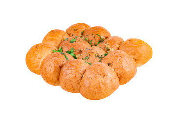 One lush baked bun with garlic, parsley, dill, cheese and other spacy isolated on white background. Ukrainian cuisine