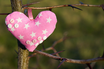 An image of a soft toy in the shape of a heart. Handicraft work.