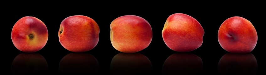 set of juicy, ripe plums isolated lie on a black background