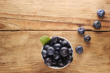 Fresh  blueberries on wooden background.