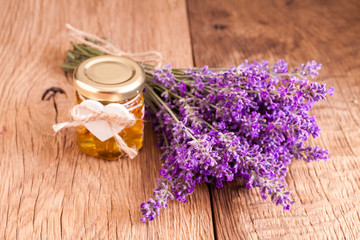 Lavander with aromatic oil on old wooden background