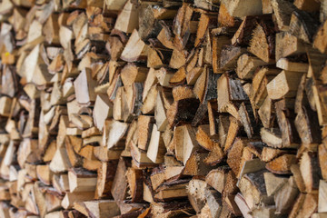 Beautiful countryside view of timber firewood stacked in a big stack near home in a countryside village home. 