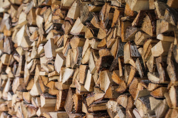 Beautiful countryside view of timber firewood stacked in a big stack near home in a countryside village home. 