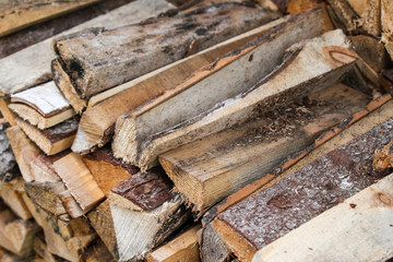 Beautiful countryside view of timber firewood stacked in a big stack near home in a countryside village home. 