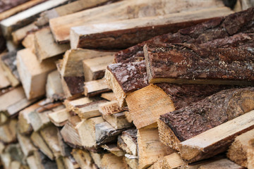Beautiful countryside view of timber firewood stacked in a big stack near home in a countryside village home. 