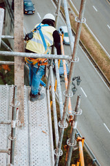 workers work removing a scaffolding at high altitude in Oviedo, Asturias, Spain.