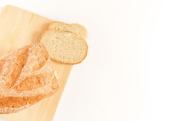 Loaf of bread cut into slices on wooden cutting board. Bread on Slicing board. Copy space. Bakery, food concept. Fresh baked bread.