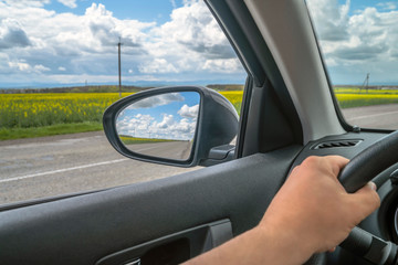 Fototapeta na wymiar Car trip. Road view reflection on side mirror