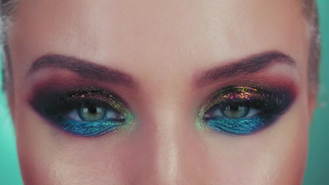 Fashion eyes makeup. Close up of a eyes models with glitter on the eyelids. Blue eyes 