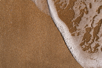 Wet sand and sea foam background
