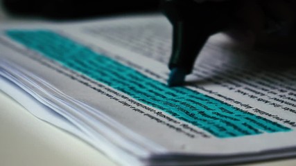 Marking some notes in a notebook while learning and reading. Studying for exam. Analyzing data. - Powered by Adobe