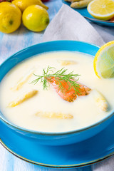 Cream of asparagus soup with salmon rolls and dill
