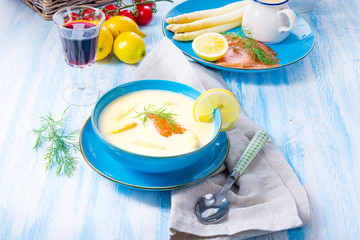 Cream of asparagus soup with salmon rolls and dill