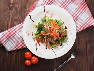 Marinated mushrooms and sausage in vegetable salad