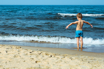 Summer time on beach and small boy 
