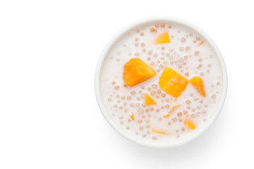 A bowl of sweet sago cream with mango and coconut milk on white background.Top view. - obrazy, fototapety, plakaty