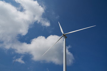 Big windmill in the blue sky and cloud of midday 