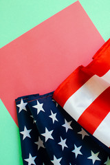 American flag on a light green and coral background.