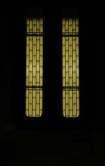 illuminated classic glass door with iron decorations at night - mysterious private house or villa entrance.