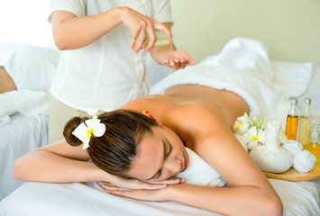 Fototapeta na wymiar Beautiful young Asian woman sleep relaxing in the Oil spa massage in salon.