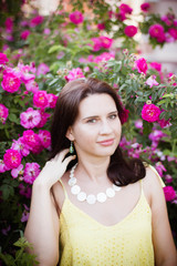 portrait of a young girl in pink rose hips