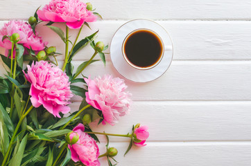 Pink peony flowers on white wooden table. womans day or wedding background.