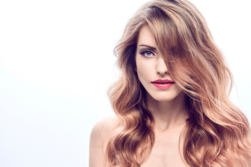 Fototapeta premium Beauty fashion woman portrait. Sensual young blonde with trendy wavy hairstyle healthy skin, makeup. Beautiful smiling positive model girl, fashionable styling curly hair. Skincare make up concept