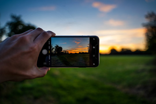 Taking a photo of the sunset with a smartphone