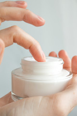 Beauty woman holding a glass jar of skin cream. Hand Skin Care. Take care of your body skin. Health and beauty concept. Top view. Copy space.