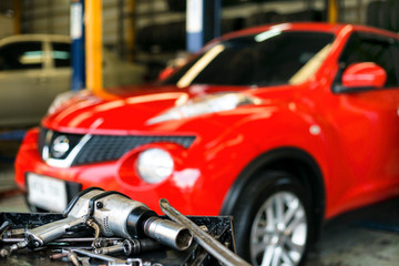 Fototapeta na wymiar Mechanic equipment , changing and adjusting car wheel in auto repair shop