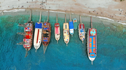 Boats in the sea, top view. Aerial view of colorful boats standing abreast on the shores of the...