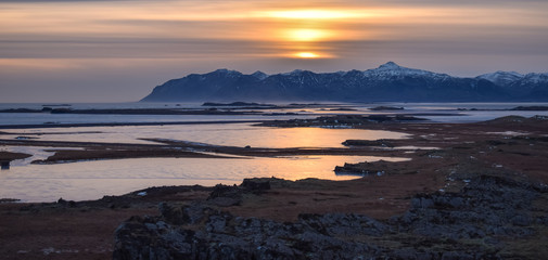  Iceland natural landscape in winter with snowy mountains and the ocean at sunset. © franciscojavier