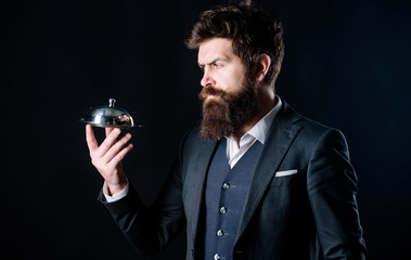 Man well groomed bearded gentleman formal suit hold little cloche. Serving and presentation. Elite luxurious. Secret under cloche. Exclusive food hidden cloche. Here is your meal. Something special