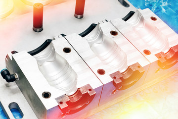 A closeup of an aluminum mold template for making plastic bottles