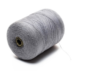 Big spool of gray threads on a white background