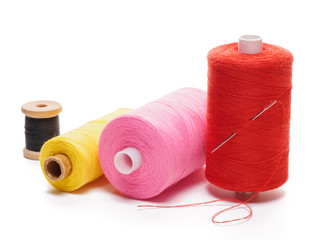 Coils yellow, red, black and pink threads with a needle white background