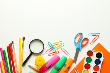 Flat lay composition with school supplies on white background, space for text