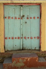 Old colorful wooden door in ancient streets of Bukhara, Uzbekistan.