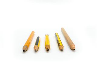 Group of lined up pencils on a white background