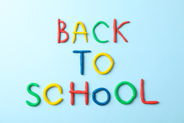Inscription back to school on color background, space for text
