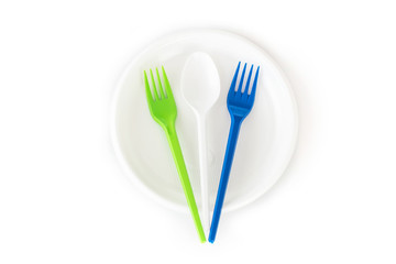 Disposable plastic plates, spoon and forks isolated on white background.  Picnic tableware set. Top view.