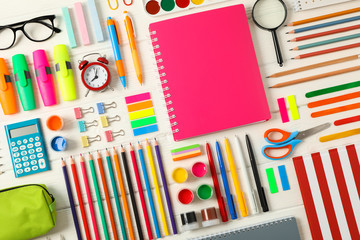 Flat lay composition with school supplies on white wooden background