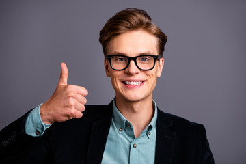 Close up photo amazing him his guy macho specs perfect appearance hairstyle hand arm thumb finger raised up advising good quality service formal-wear shirt velvet jacket isolated grey background