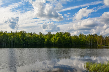 Beautiful white clouds over a tranquil lake