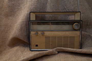 old soviet tape recorder on a flax texture background
