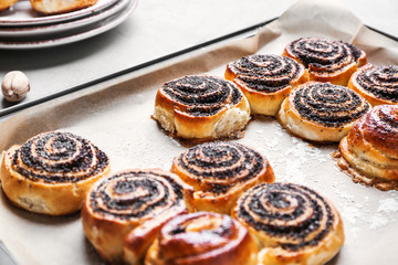 Tasty poppy buns on baking tray