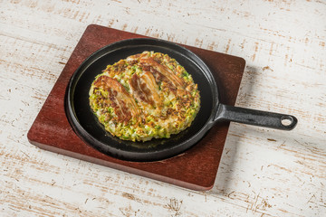 お好み焼き Okonomiyaki is a Japanese-style pancake