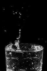 water drops splashing in the glass of water