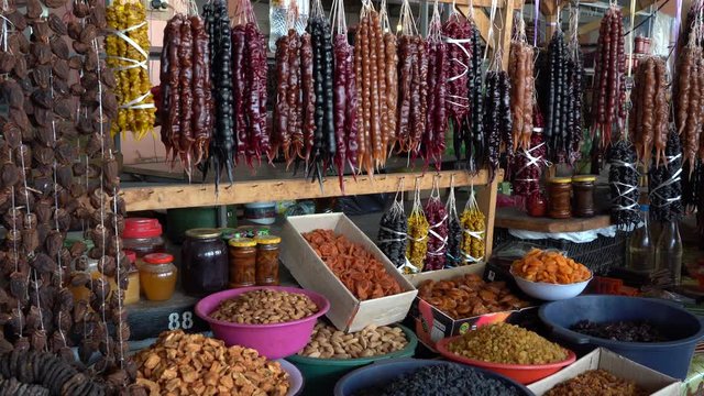 Churchkhela. Traditional Georgian homemade sweets with hazelnuts, walnuts, grape juice, honey or sugar, wheat flour or corn flour . Dessert sold in local food market in Georgia, Tbilisi or Batumi