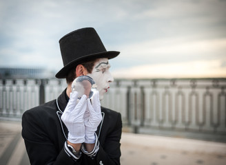Mime on the street waiting to meet with his lover
